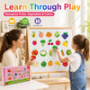 A woman and a child learn fruits, vegetables, and colors using a magnetic learning set.