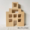 A light wood acrylic building block shaped like a house with cutout windows and a doorway.