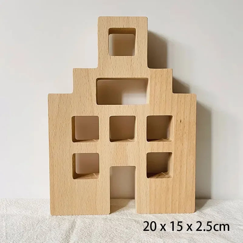 A light wood acrylic building block shaped like a house with cutout windows and a doorway.