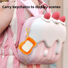 A pink and white striped backpack features a mini magnetic drawing board keychain with an orange stylus attached.