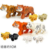 A set of six wooden building blocks depicting various African wildlife animals including tigers, lions, and other creatures.