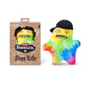 A yellow and green plush toy monster with human-like teeth wearing a black cap, displayed next to its packaging.