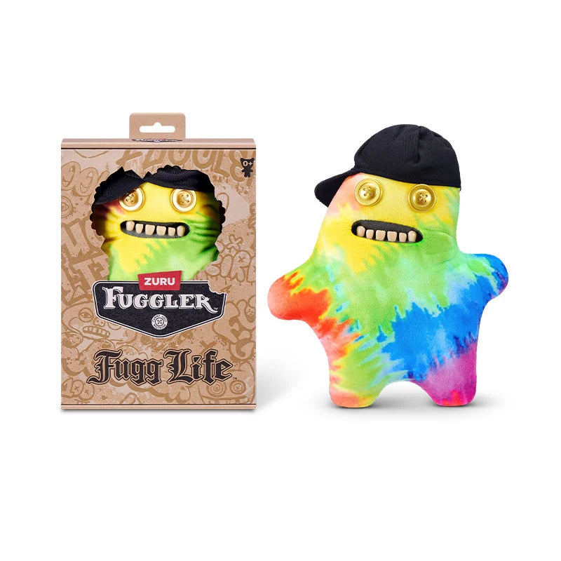 A yellow and green plush toy monster with human-like teeth wearing a black cap, displayed next to its packaging.
