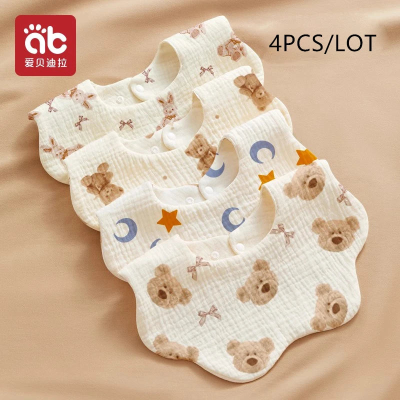 A stack of four soft cotton gauze baby bandana bibs featuring a teddy bear pattern in beige and white.