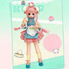 A pink-haired BJD collectible doll with a frilly dress and pink hair accessories standing against a light green background.
