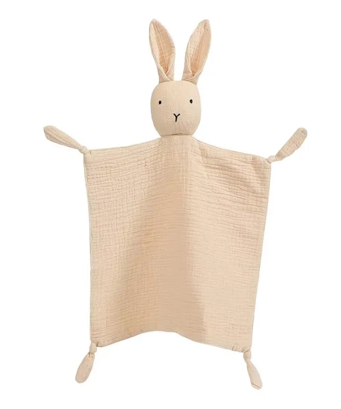A light beige soft cotton muslin baby comforter blanket shaped like a rabbit.