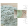 Close-up of a soft, light blue sea turtle plush toy with a textured, fluffy surface.