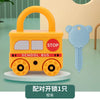 An orange toy school bus with a handle and wheels, featuring a stop sign, next to a blue key shaped like an elephant.