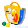 An orange box for a U-shaped juggling ball skill toy with green and yellow balls.