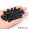 A handful of black volcanic lava round beads for jewelry making