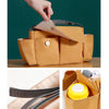 A tan universal stroller organizer bag showing its interior and strap details.