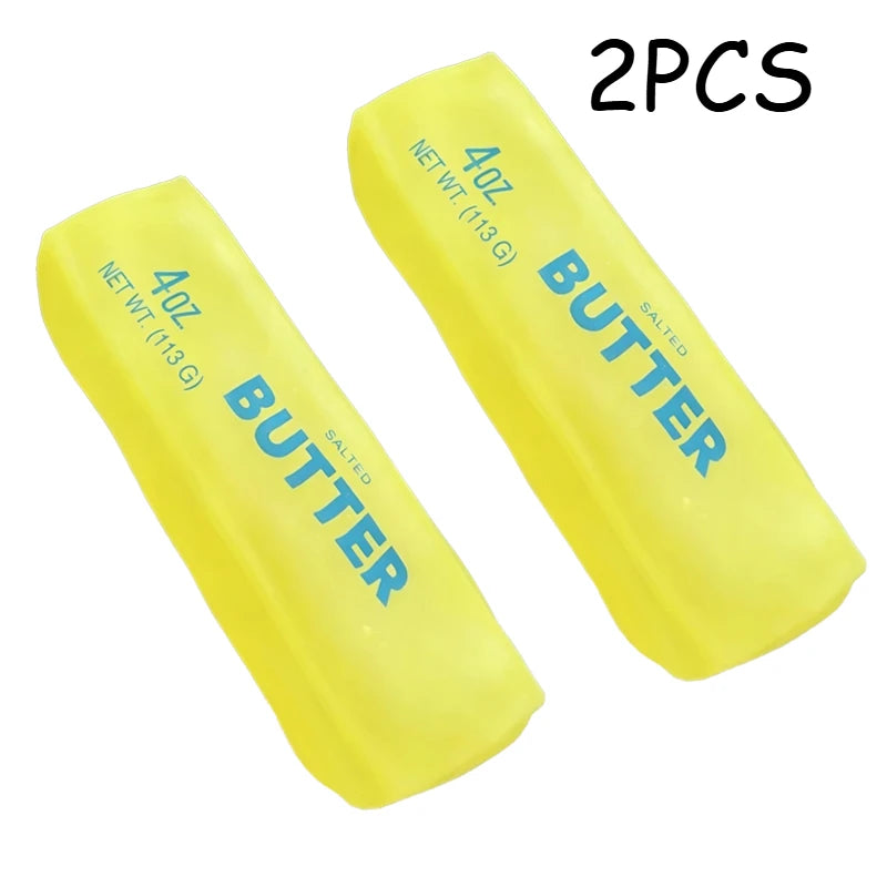 Two yellow salted butter sticks, 4oz each, used as a moldable squishy stress relief fidget toy.