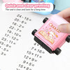 A pink roller stamp used for clear and lasting printing of multiplication and division math problems on paper.