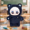 A plush collectible figure of Gojo Satoru in a cat costume with white hair and glasses sitting on a wooden table.