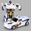 A white transforming diecast robot car model with a police theme, featuring a cockpit and robotic arms.