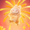 A fluffy orange Labubu vinyl plush pendant with large eyes and a wide smile against an orange background.