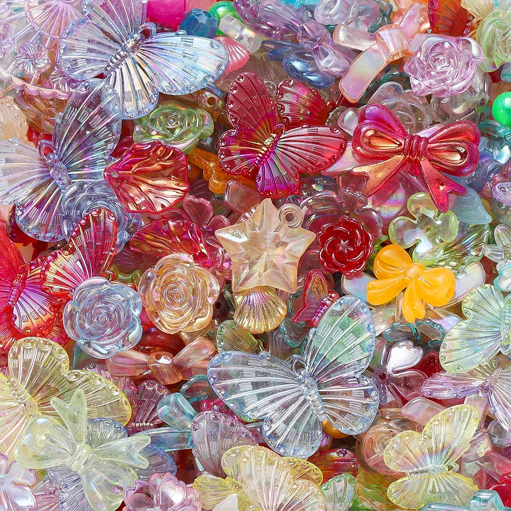 A close-up of colorful butterfly shell acrylic beads in various shades of pink, purple, green, and orange.