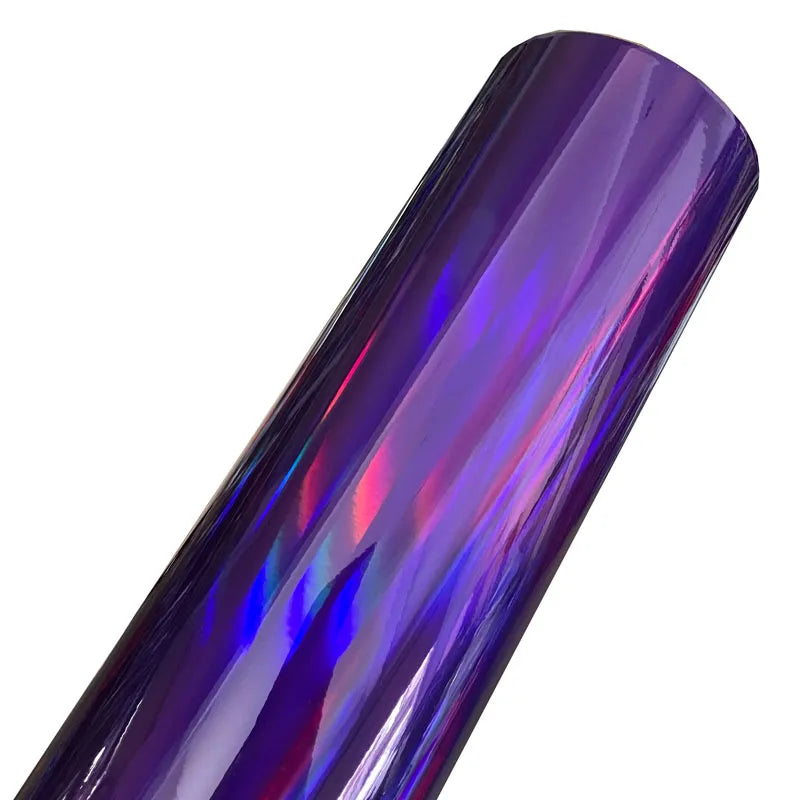 A close-up view of a roll of holographic chrome vinyl wrap featuring rainbow iridescent colors.