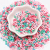 A pink bowl filled with colorful polymer clay sprinkles mix for slime decor and DIY craft accents.