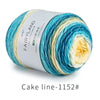 A ball of silky yarn featuring a gradient blend of blue, teal, and cream colors for knitting or crochet projects.