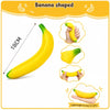 Banana shaped squishy toy in yellow and green, shown from the side and being held.
