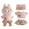 A set of knitted clothing and accessories for a doll figure including a sweater, hat, and shorts.