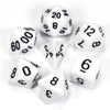 A collection of white acrylic dice, including d20s and d12s, scattered on a white surface.