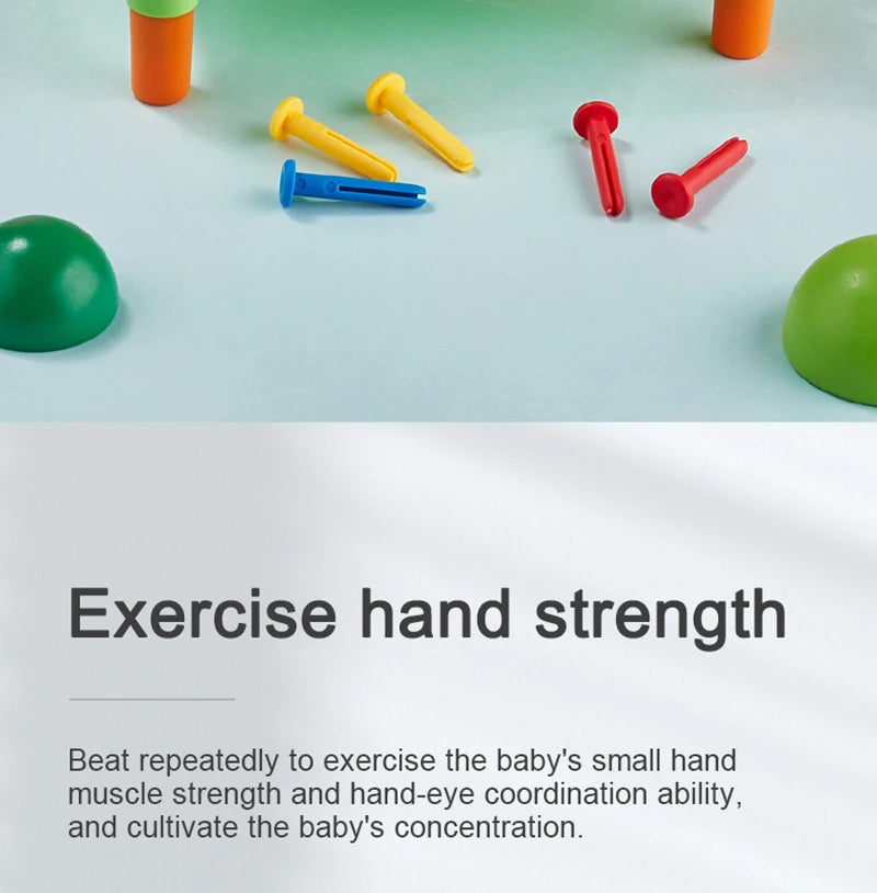 A collection of colorful hammer nails and a green ball on a light blue surface for fine motor skill exercise.