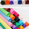 A collection of colorful crepe paper rolls in various shades including green, pink, yellow, blue, and orange.