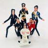 A collection of seven iconic abstract Michael Jackson plush dolls with movable joints in various outfits and poses.