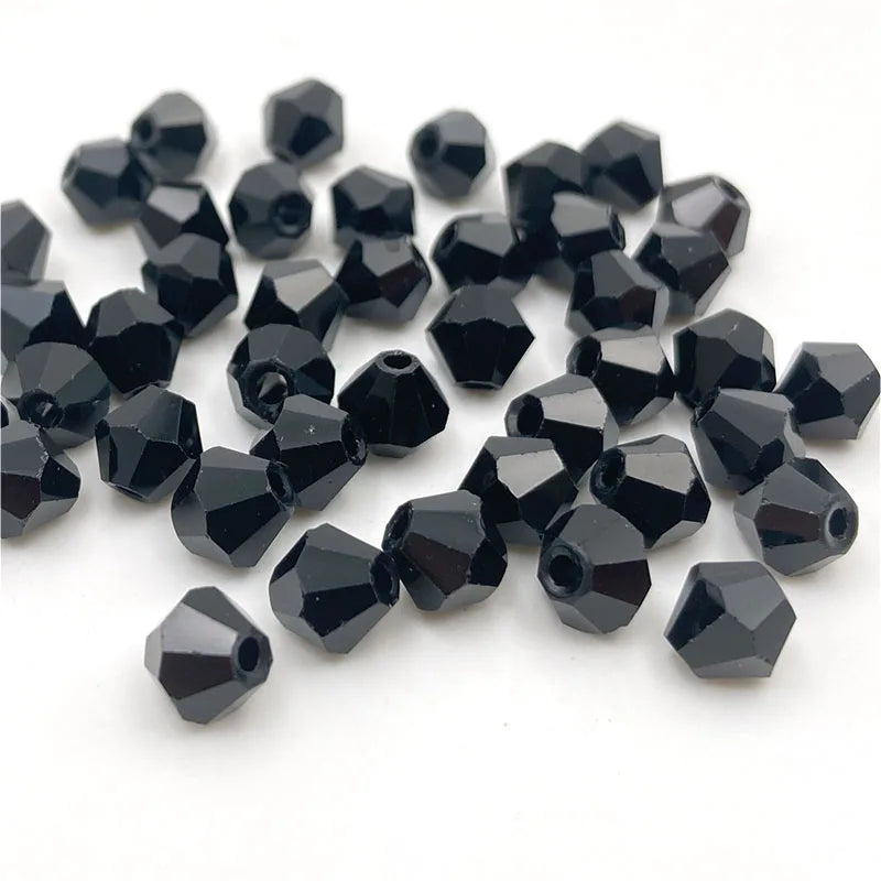 A pile of faceted black bicone crystal glass beads for jewelry making