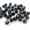 A pile of faceted black bicone crystal glass beads for jewelry making