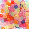 A large pile of colorful rainbow pony beads in various shades including pink, orange, yellow, and blue.