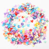 A circular arrangement of colorful polymer clay sprinkles in various pastel shades like pink, blue, and yellow.