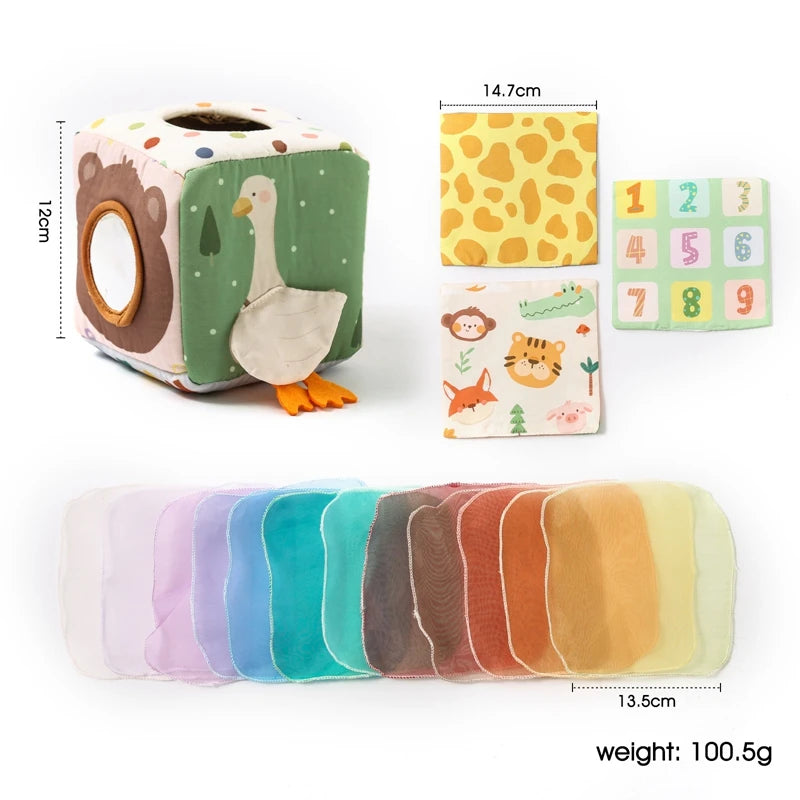 A soft fabric tissue box sensory toy featuring a duck design and colorful fabric tissue rolls.