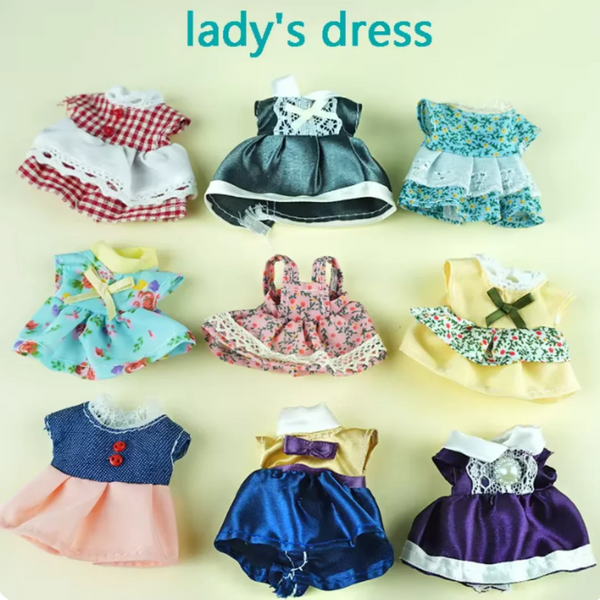 A collection of various lady's dresses and outfits for a doll, including floral prints and different colors.