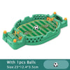 A green tabletop foosball game set with rods and balls on a green playing surface.
