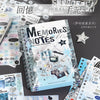 A spiral-bound notebook filled with various decorative stickers and notes, displayed next to a silver star sticker.