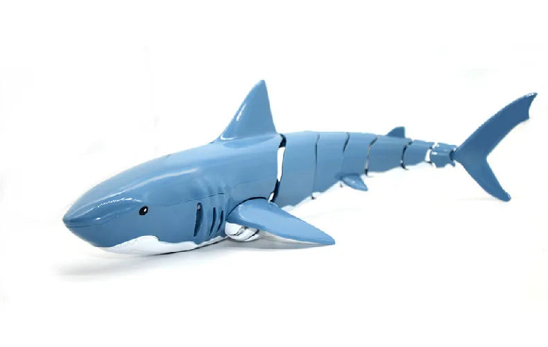 A light blue remote control shark toy with a white snout and fins, shown in profile.