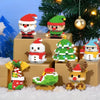 Christmas micro building block set featuring Santa and reindeer figures displayed on a wooden table with a decorated Christma