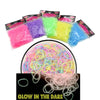 A collection of glow-in-the-dark colored fibers and plastic sheets for making loom band bracelets.