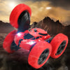 A red RC drift racer car with large tires is shown in a dynamic stunt pose against a dark, dramatic background.