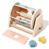 A wooden hand bell for sensory play with a light wood frame and colorful internal components.
