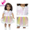 A doll wearing a pink and yellow outfit set consisting of a blouse, skirt, and tights.