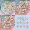 A collection of iridescent and pearl-colored acrylic beads shaped like various ocean animals for DIY jewelry making