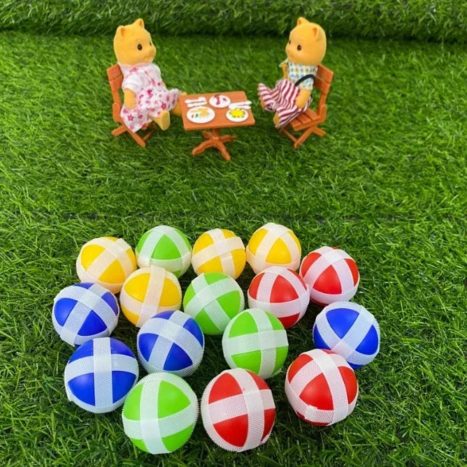 A set of colorful sticky balls used for a target shooting game, including yellow, green, and red balls.