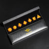 A set of six yellow and orange resin polyhedral dice displayed inside a dark gray box labeled Mini Planet.