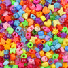 A close-up of a large pile of colorful pony beads in various shapes and colors for jewelry making and crafts.