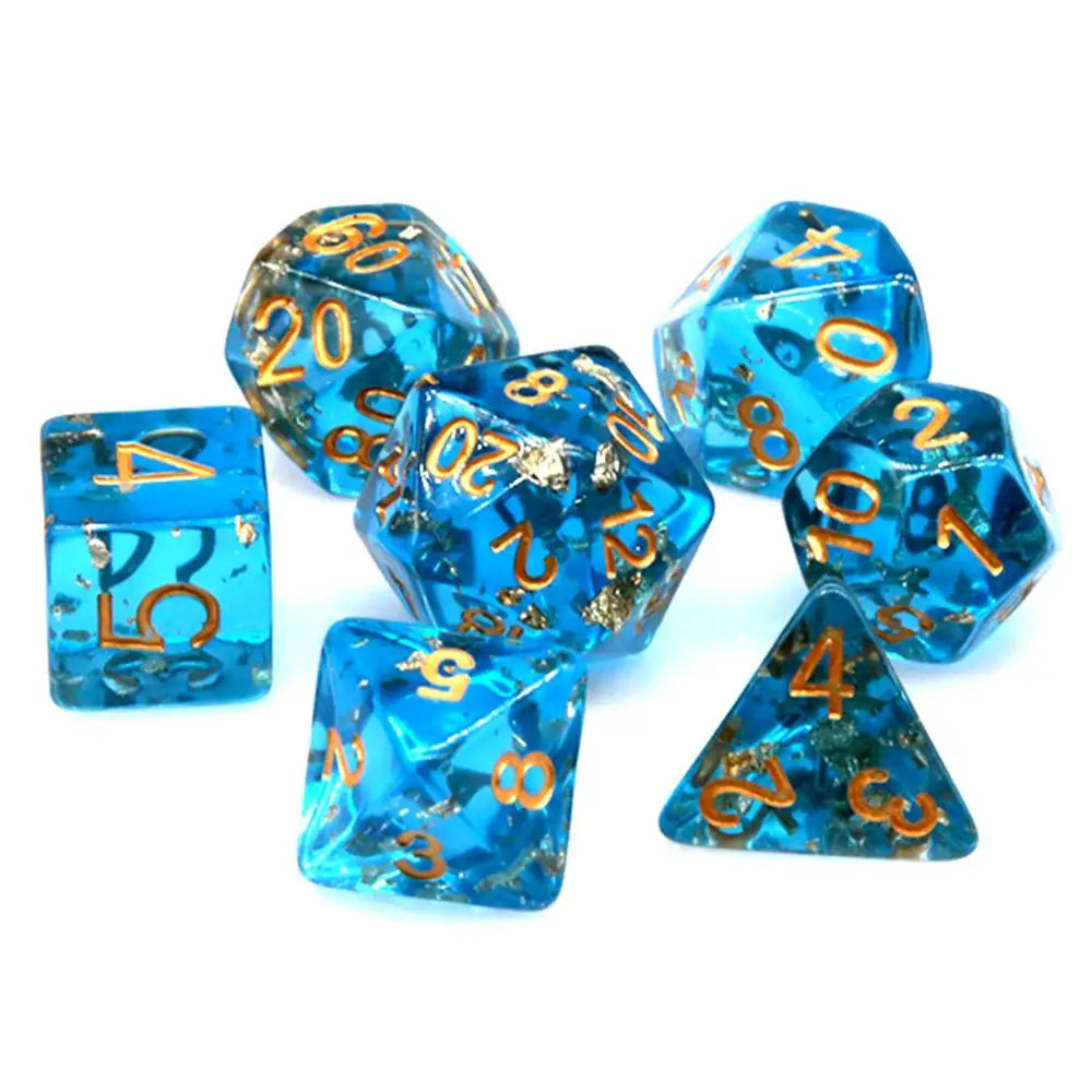A set of bright blue resin dice with gold foil numbers and dots scattered on a white background.