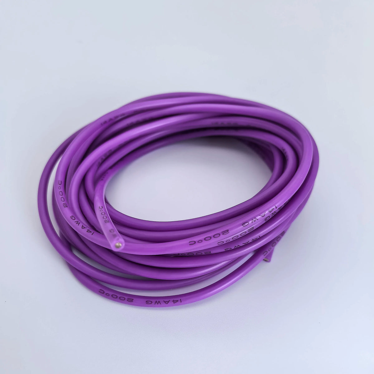 A coil of purple flexible silicone tinned copper wire with various AWG gauges.